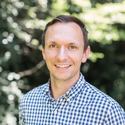 Andrew Johansen smiling while standing outside.